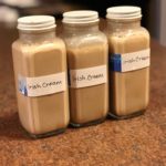 Three rectangular bottles filled with tan liquid labelled as Irish Cream.