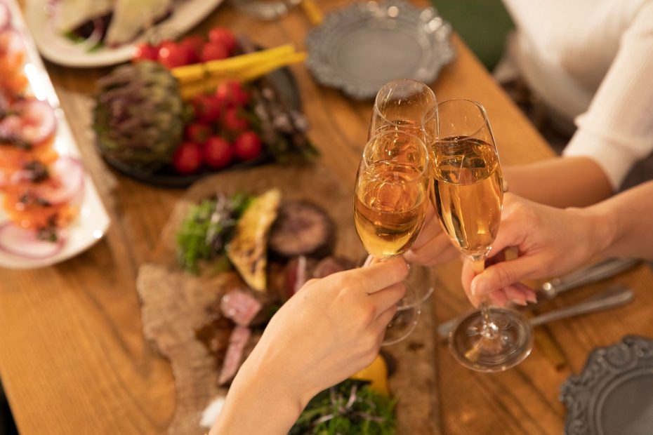 Glasses clinking over a range of appetizers