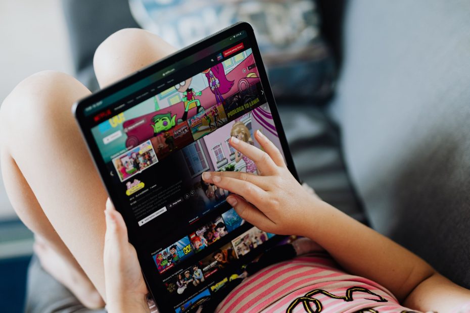 Cute boy, playing on tablet in the car